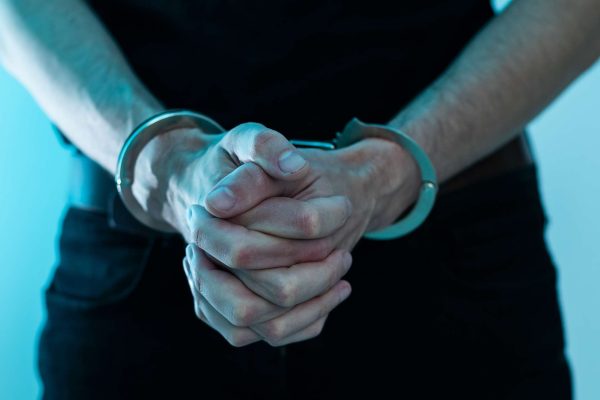 bigstock-Arrested-Man-Handcuffed-Hands--477905915s